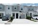 Modern townhome exterior with two-car garages and well-kept lawns at 7433 Stone Creek Trl, Kissimmee, FL 34747