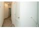 Bright hallway with neutral carpet, white walls, and doors at 7433 Stone Creek Trl, Kissimmee, FL 34747