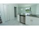 Modern kitchen with stainless steel appliances, gray countertops, and white cabinets at 7433 Stone Creek Trl, Kissimmee, FL 34747