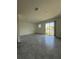 Bright living room featuring tile flooring and sliding glass doors to a pond view at 7433 Stone Creek Trl, Kissimmee, FL 34747