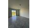 Bright living room featuring tile flooring and sliding glass doors to a pond view at 7433 Stone Creek Trl, Kissimmee, FL 34747