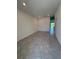 Bright living room featuring neutral-toned tile flooring that leads into the hallway at 7433 Stone Creek Trl, Kissimmee, FL 34747