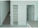 Open pantry with shelves next to a staircase at 7433 Stone Creek Trl, Kissimmee, FL 34747