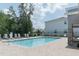 Community pool with lounge chairs and patio area at 7433 Stone Creek Trl, Kissimmee, FL 34747