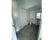 Stylish powder room with modern fixtures, tile flooring, and convenient closet at 7433 Stone Creek Trl, Kissimmee, FL 34747