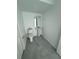 Compact powder room with a pedestal sink, modern toilet and closet at 7433 Stone Creek Trl, Kissimmee, FL 34747