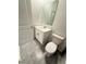 Well-lit powder room featuring a modern vanity and toilet at 7433 Stone Creek Trl, Kissimmee, FL 34747