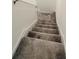 Carpeted staircase leading to upper level, providing comfortable and safe access at 7433 Stone Creek Trl, Kissimmee, FL 34747