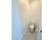 A view of the toilet in the bathroom with neutral-colored tiled flooring at 7433 Stone Creek Trl, Kissimmee, FL 34747