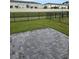 A private backyard offers a peaceful setting with a brick patio and a serene view of the water at 2453 Magnolia Reserve Rd, Ocoee, FL 34761