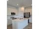 Bright kitchen boasts an island, white cabinetry, stainless steel appliances, and modern fixtures at 2453 Magnolia Reserve Rd, Ocoee, FL 34761