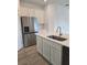 Modern kitchen featuring stainless steel appliances, white cabinets, and an island with a sink at 2453 Magnolia Reserve Rd, Ocoee, FL 34761