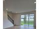 Spacious living room featuring hardwood floors, recessed lighting, and sliding glass doors to the backyard at 2453 Magnolia Reserve Rd, Ocoee, FL 34761
