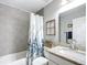 Bright bathroom with a tub, white vanity, granite countertop, and a floral shower curtain at 12396 Sw 64Th Street Rd, Ocala, FL 34481