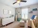 bedroom with a blue accent wall, wood laminate flooring, and a custom surfboard at 12396 Sw 64Th Street Rd, Ocala, FL 34481