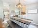 Open dining area with dark wood table, chandelier, and view into kitchen and living spaces at 12396 Sw 64Th Street Rd, Ocala, FL 34481