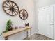 Welcoming entryway featuring rustic decor, a decorative table, and light wood-look flooring at 12396 Sw 64Th Street Rd, Ocala, FL 34481