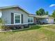 Beautifully landscaped yard surrounding a well-maintained home with stone detailing and inviting curb appeal at 12396 Sw 64Th Street Rd, Ocala, FL 34481