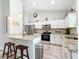 Bright kitchen featuring granite countertops, white cabinets, stainless steel appliances, and a breakfast bar at 12396 Sw 64Th Street Rd, Ocala, FL 34481