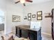 Home office featuring a large, traditional desk, wood laminate flooring, and ceiling fan at 12396 Sw 64Th Street Rd, Ocala, FL 34481