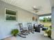 Inviting covered patio with rocking chairs and serene view at 12396 Sw 64Th Street Rd, Ocala, FL 34481