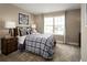 Cozy bedroom with plaid bedding, a window view, and sports-themed decor at 1722 Upland Ln, Winter Haven, FL 33884