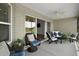 Relaxing screened back porch boasts comfortable seating, ceiling fan and views of the green backyard at 3315 Dzuro Dr, Oxford, FL 34484