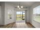 Bright dining area with sliding glass doors and serene outdoor views at 3315 Dzuro Dr, Oxford, FL 34484