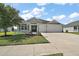 Charming single-Gathering home with a well-maintained lawn and attached two-car garage at 3315 Dzuro Dr, Oxford, FL 34484