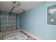 Spacious garage with garage door, light blue walls, and light-colored painted floor at 3315 Dzuro Dr, Oxford, FL 34484