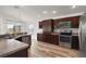 Modern kitchen with stainless steel appliances, wood cabinets, and a breakfast bar at 3315 Dzuro Dr, Oxford, FL 34484