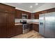 A spacious modern kitchen features stainless steel appliances and wooden cabinets at 3315 Dzuro Dr, Oxford, FL 34484