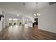 Spacious living room with wood floors and sliders leading to the lanai at 3315 Dzuro Dr, Oxford, FL 34484