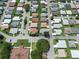 Birds-eye view of a quiet residential area with tree-lined streets and well-kept homes at 4856 Colonnades W Cir, Lakeland, FL 33811