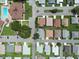 Aerial view of a well-maintained residential neighborhood with green spaces and manicured lawns at 4856 Colonnades W Cir, Lakeland, FL 33811