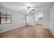Bright bedroom featuring neutral walls, wood-look floors, and ample natural light from two windows at 4856 Colonnades W Cir, Lakeland, FL 33811