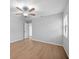 Neutral bedroom with a ceiling fan and hardwood floors, providing ample space and comfort at 4856 Colonnades W Cir, Lakeland, FL 33811