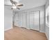 Neutral bedroom featuring hardwood floors, a closet, and natural light filtering through the window at 4856 Colonnades W Cir, Lakeland, FL 33811