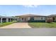 Inviting single-story home with a covered carport, manicured lawn and beautiful curb appeal at 4856 Colonnades W Cir, Lakeland, FL 33811