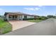 Charming single-story home featuring a covered carport and well-maintained landscaping at 4856 Colonnades W Cir, Lakeland, FL 33811