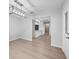 Open-concept living area with modern lighting and hardwood floors, seamlessly flowing into the kitchen at 4856 Colonnades W Cir, Lakeland, FL 33811