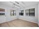 Bright, spacious living area with hardwood floors and natural light streaming through multiple windows at 4856 Colonnades W Cir, Lakeland, FL 33811