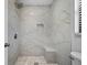 Luxurious walk-in shower with marble tile and a built-in bench for ultimate relaxation and comfort at 4856 Colonnades W Cir, Lakeland, FL 33811