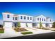 Charming townhomes feature a blue and gray exterior, well-kept lawns, and attached garages in a desirable community at 1196 Port Blue Way, Lady Lake, FL 32159
