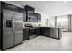 Modern kitchen features stainless steel appliances, dark cabinets, granite countertops, and a convenient breakfast bar at 1196 Port Blue Way, Lady Lake, FL 32159