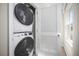 Convenient laundry area with a stacked washer and dryer unit, maximizing space efficiency at 1196 Port Blue Way, Lady Lake, FL 32159