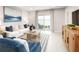 Bright living room with lake views, modern decor, and sliding glass doors leading to outdoor seating at 1252 Turtle Island Rd, Lady Lake, FL 32159