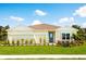 Charming single-story home with well-manicured lawn, tidy landscaping, and a decorative teal door at 1524 Covey Rise Ter, Winter Haven, FL 33884