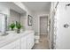 Bright bathroom with double sinks, white cabinets and modern fixtures, offering a clean and inviting space at 2307 Incandescent Way, South Daytona, FL 32119