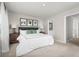 Relaxing bedroom with a white duvet, side tables and lamps, as well as convenient access to the Primary bath at 2307 Incandescent Way, South Daytona, FL 32119